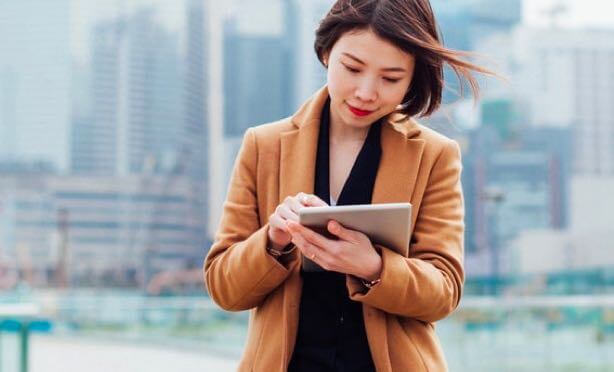 A woman using DocuSign on her tablet to manage documents