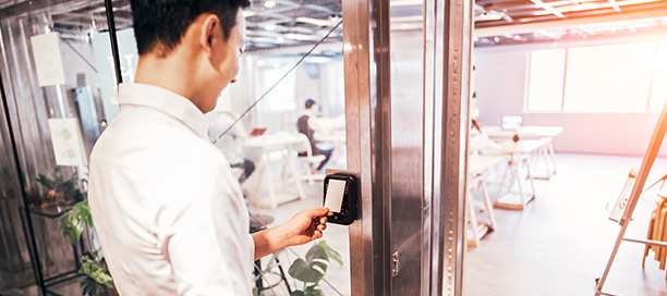 Man scanning his ID badge to access his office location.