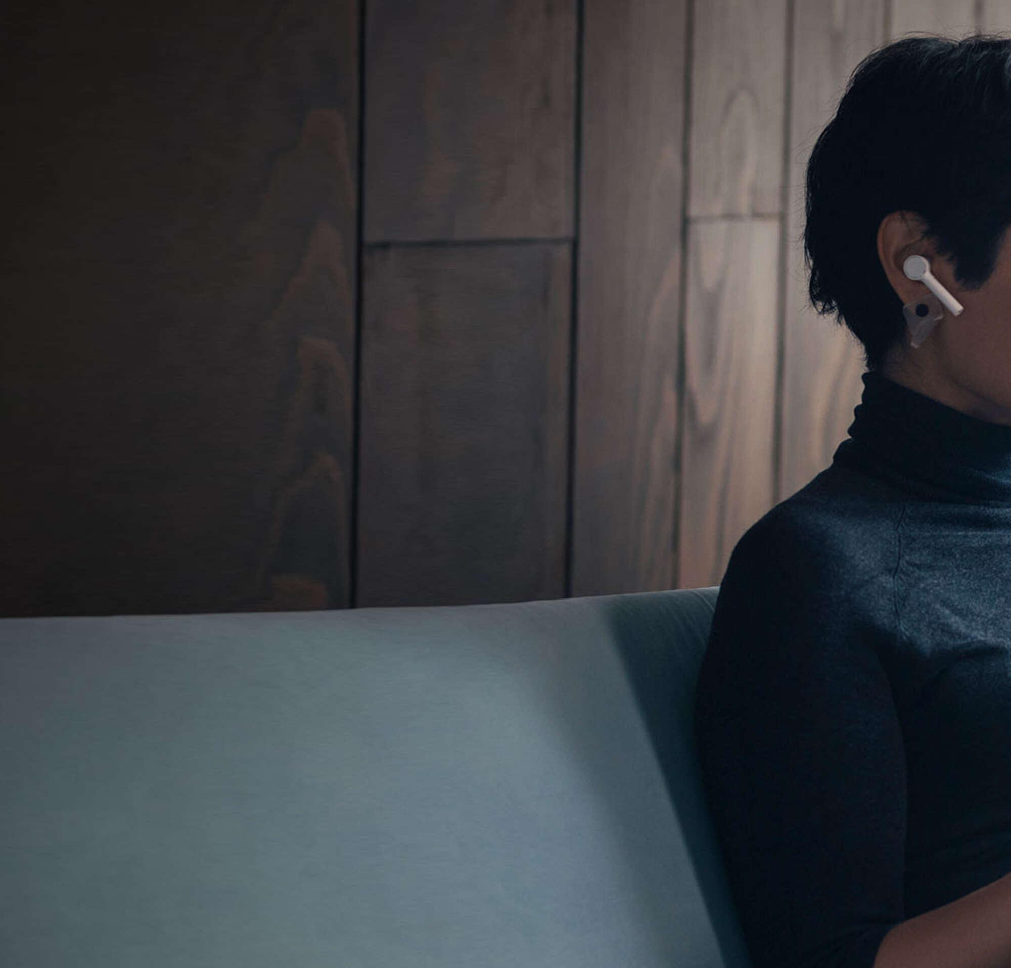 Young businesswoman using her laptop Computer and a pair of wireless earphones making a video call.